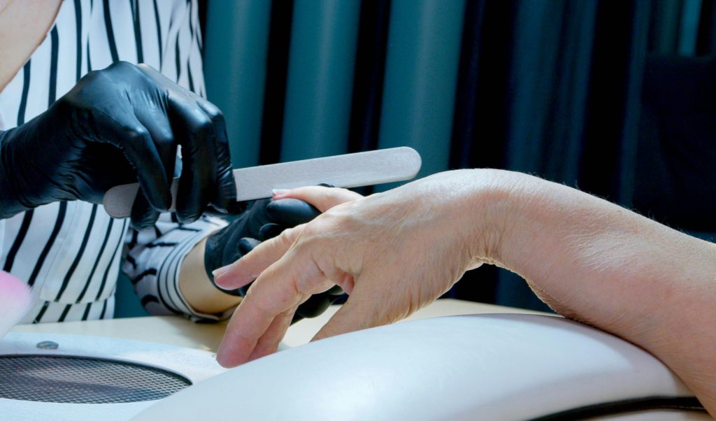 Image of nail technician giving a manicure