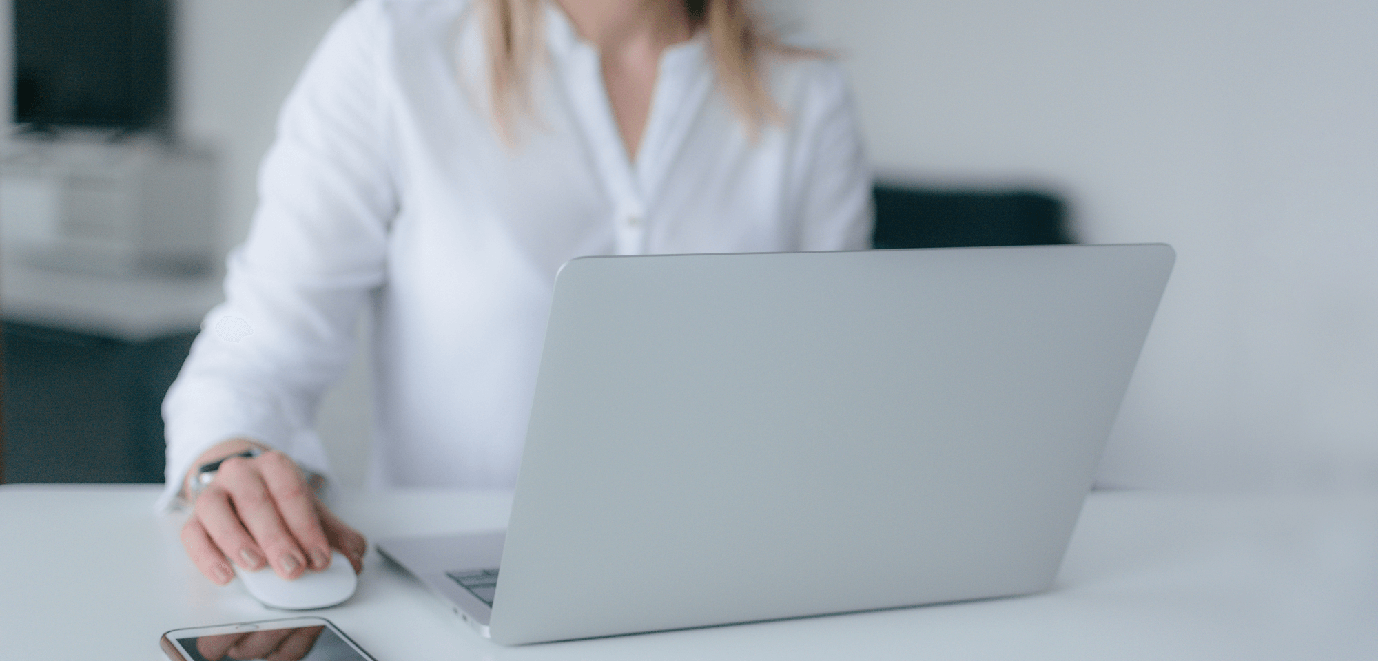 Woman writing Team EVOLVE Email Newsletter featuring organisational transformation expertise